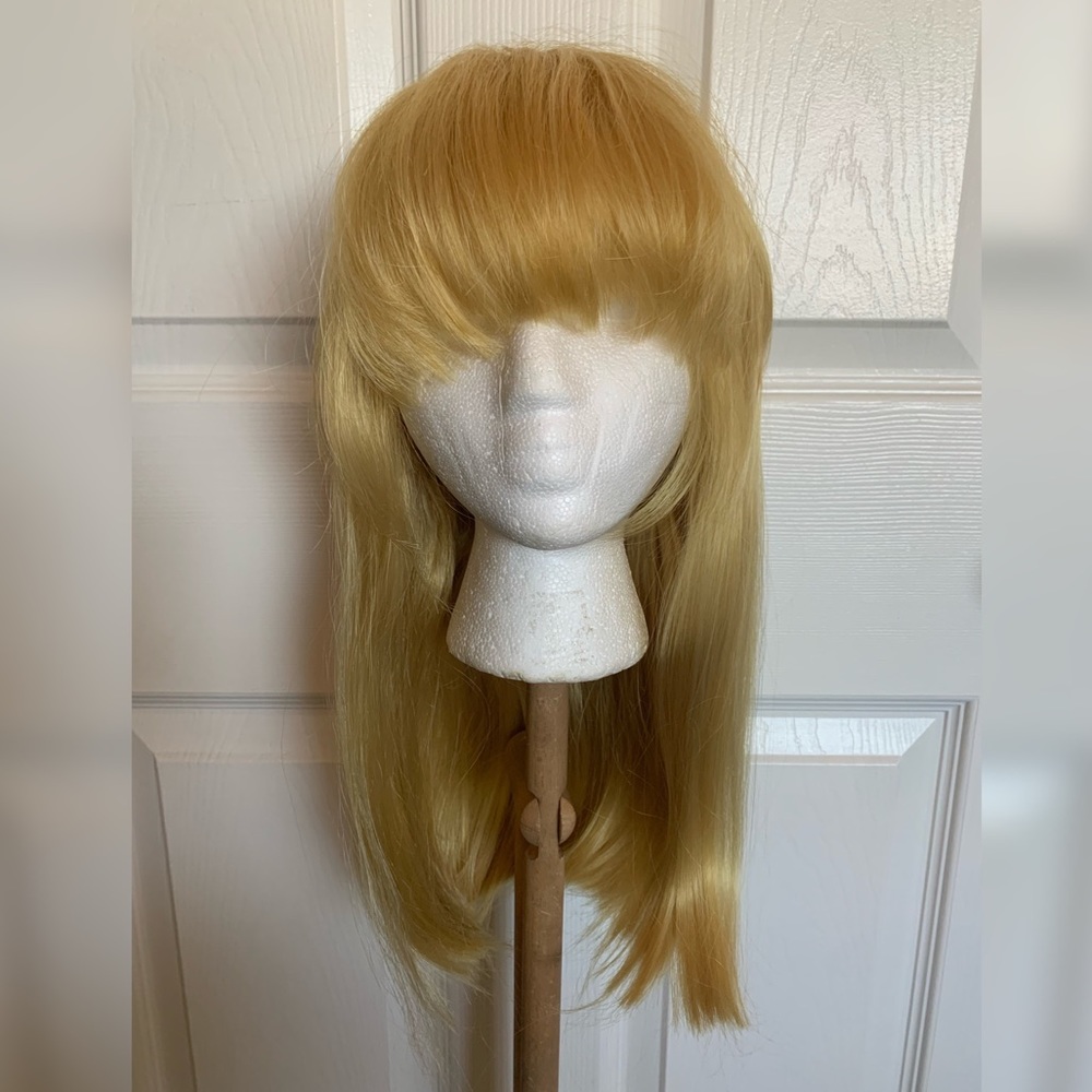 Shoulder Length Blonde Wig with Voluminous Arched Bangs and Strawberry Red Tones